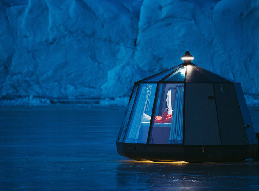 Aurora dome luxury camp at night on a frozen lake