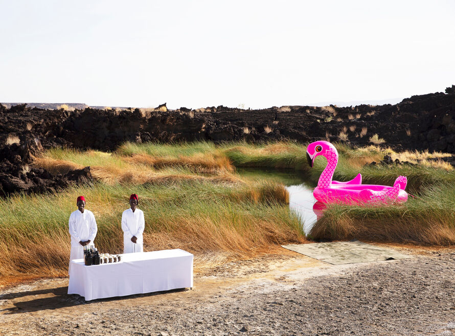 Bar setup with large inflatable pink flamingo floating in the background.