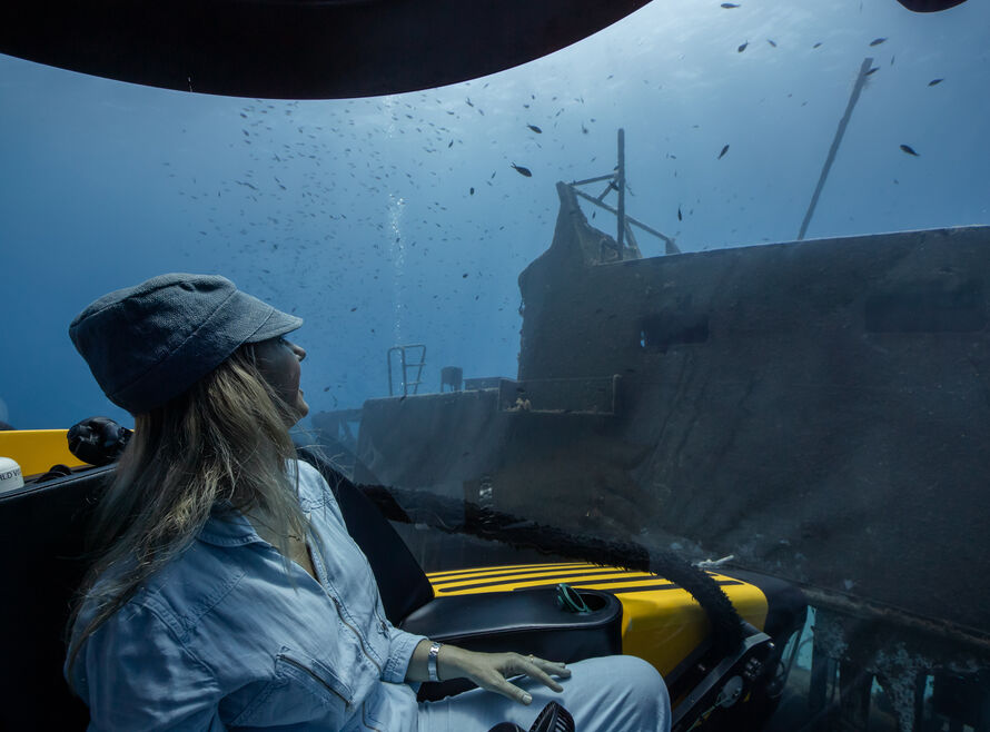 Interior of Triton submersible with guest looking out