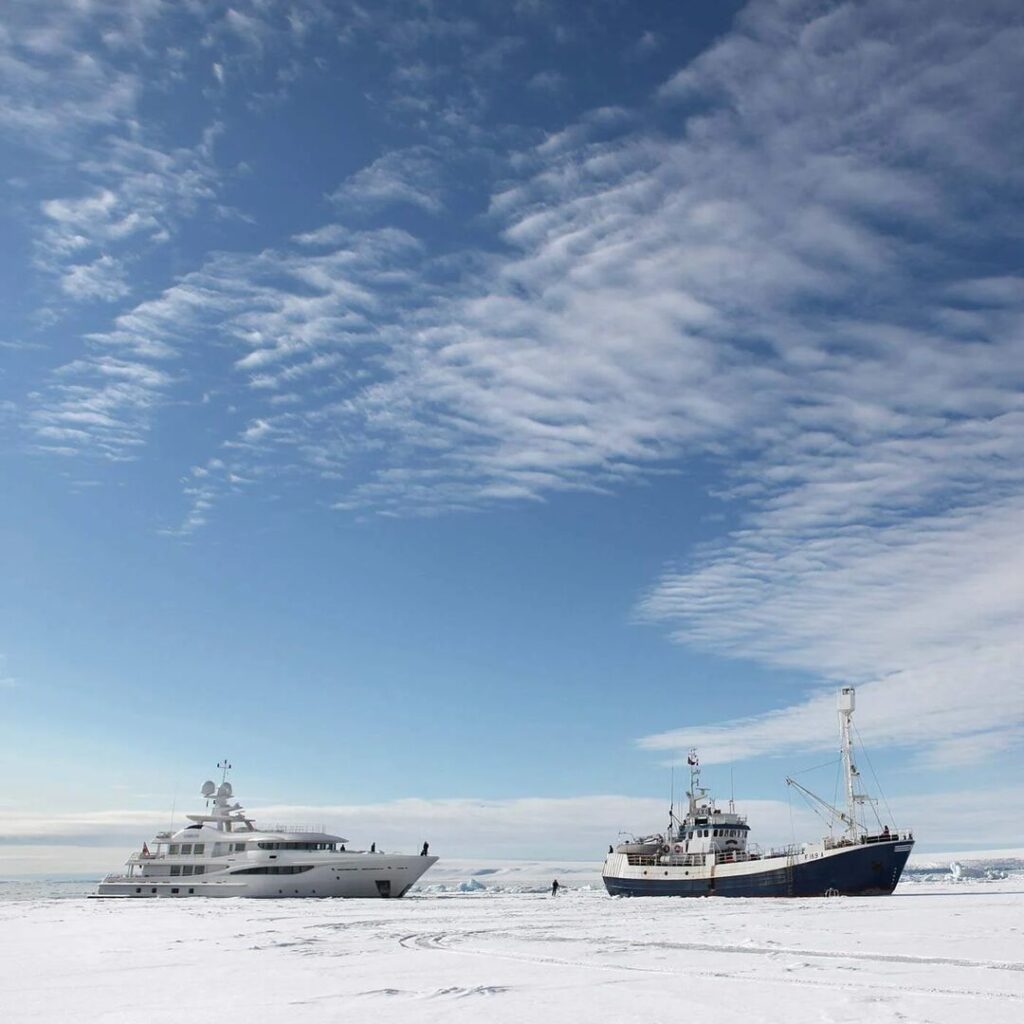 Superyacht with icebreaker in Svalbard