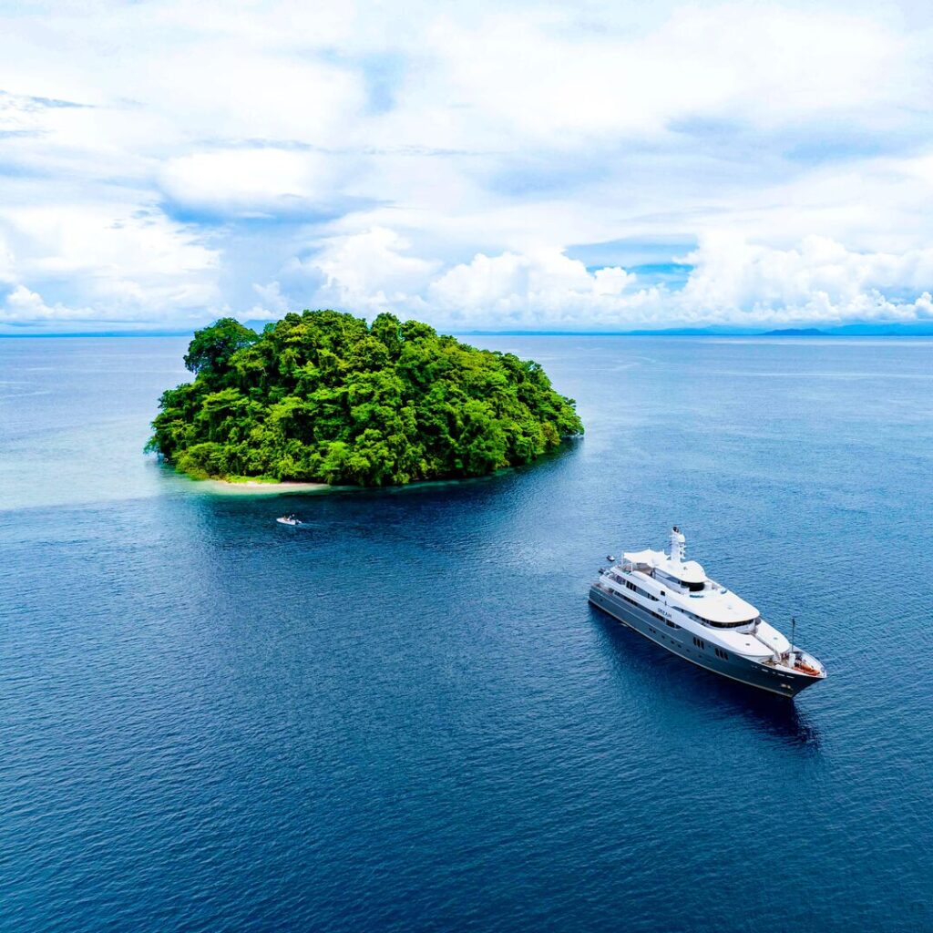 Superyacht with island in Papua New Guinea