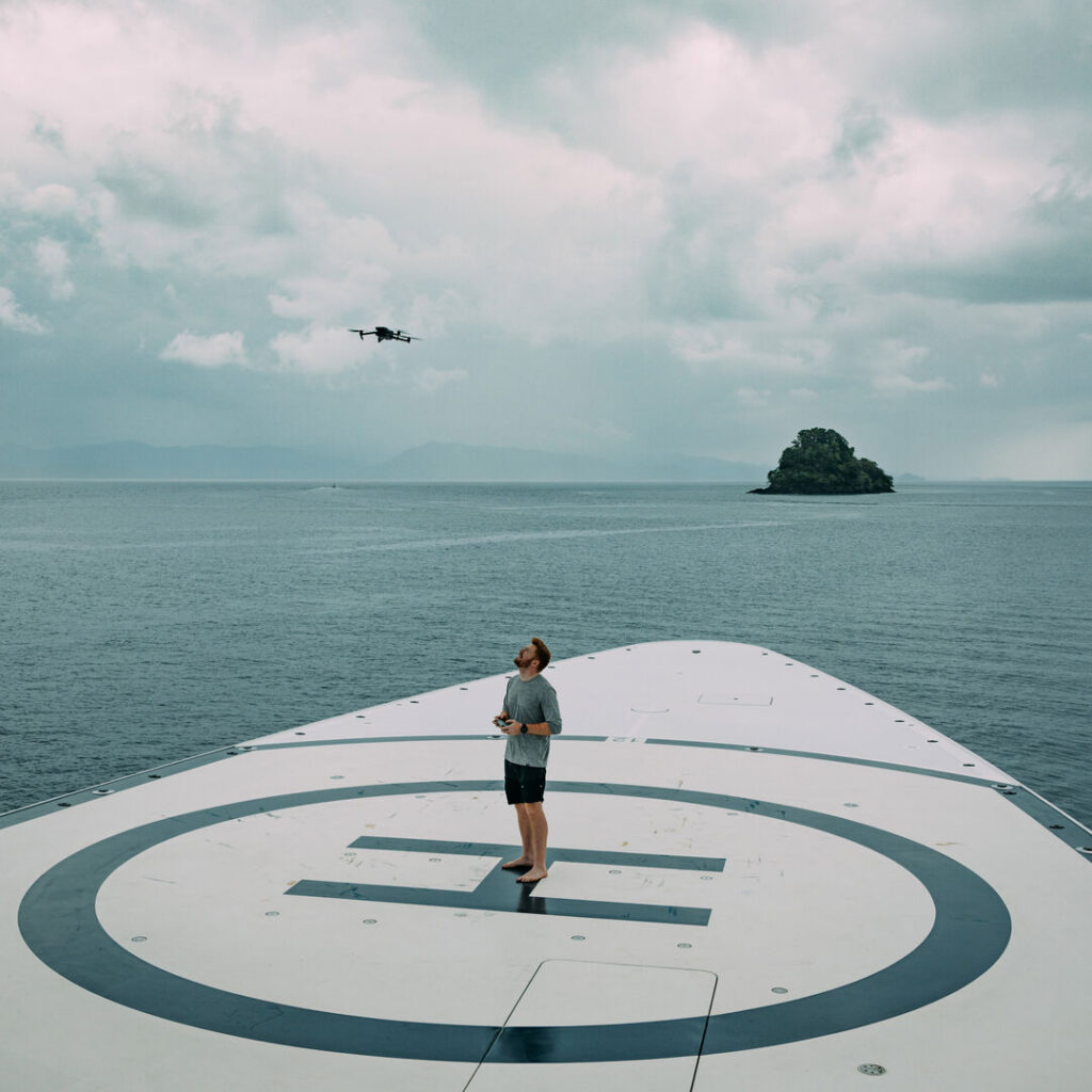 Photographer takes off a drone on a superyacht deck